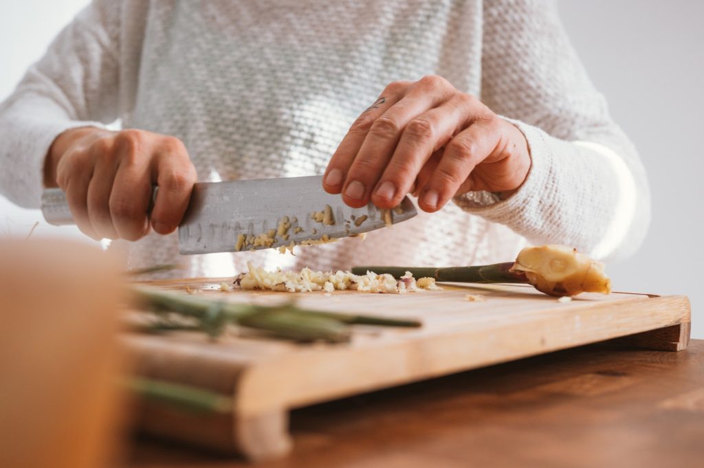 Woman chopping food on cutting board