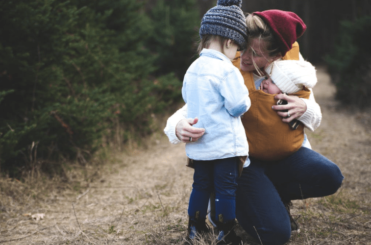 mother babywearing toddler, talking