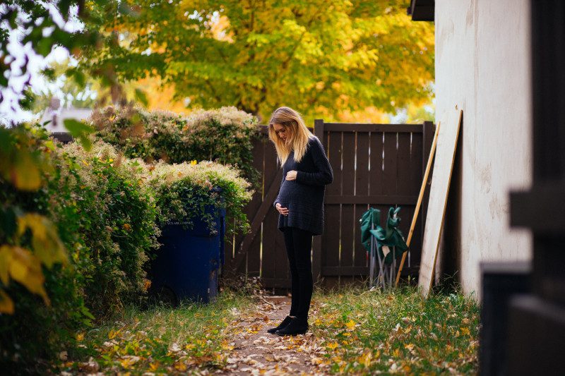 pregnant women holding belly outside