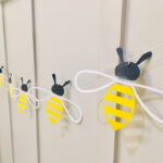 honey bee garland on wall